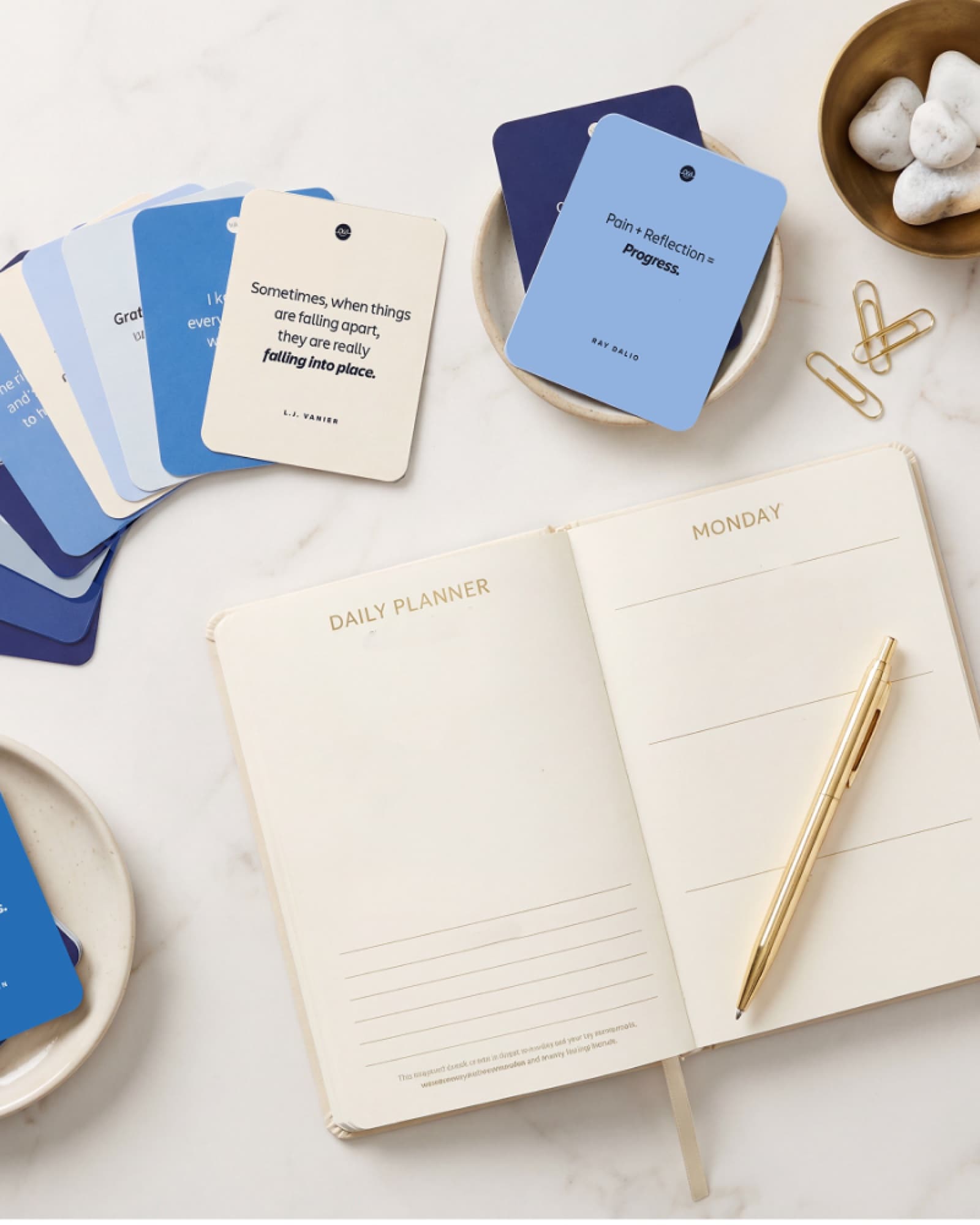 OhhWells affirmation cards spread out beside a daily planner